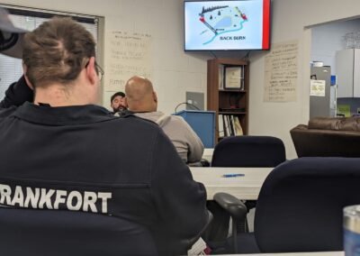 Members in a classroom watching a presentation on wildland fire tactics