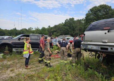 Members gather between vehicles at the training site