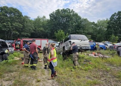 Members prepare tools beside the vehicles