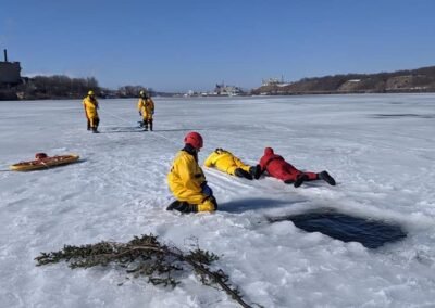 Members practice an ice rescue on frozen Manistee Lake while others stand by