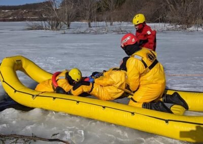 The rescue team works around the inflatable rescue boat on the ice