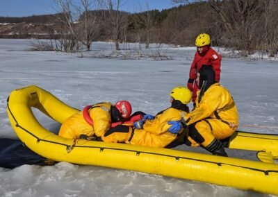 Rescuers pull a person into the inflatable rescue boat