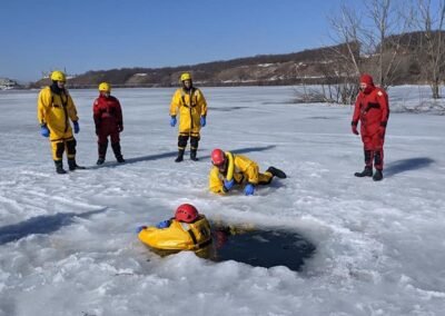 Members watch from the ice as a rescuer works at the hole