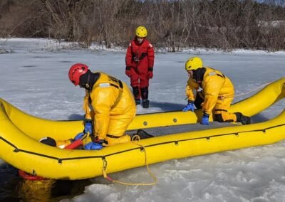 The team works the inflatable rescue boat at the hole in the ice