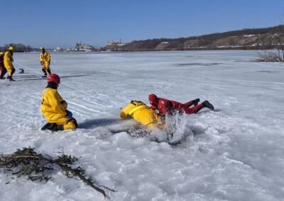 Rescuers approach the ice hole as other members stand by