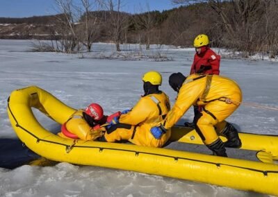 The team pulls a person into the inflatable rescue boat