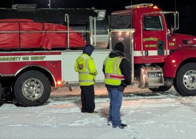 A Stronach tanker with two members in safety vests during night driver training, December 2, 2024