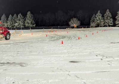 A fire engine on the snow-covered cone course at night, December 2, 2024