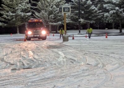 An engine coming through the cones with members in safety vests spotting, December 2, 2024