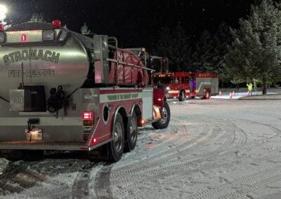 The Stronach tanker and an engine on the snow-covered course at night, December 2, 2024