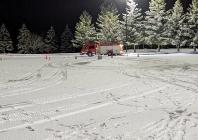 An engine at the far end of the cone course under the parking lot lights, December 2, 2024
