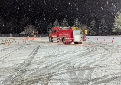 An engine working the cone course in falling snow, December 2, 2024