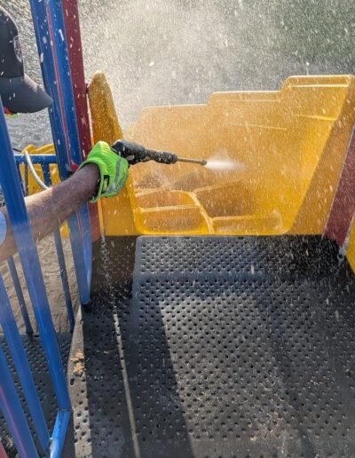 Members clean the playground equipment at Stronach Park