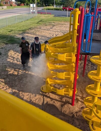 A member power-washes the playground equipment at Stronach Park