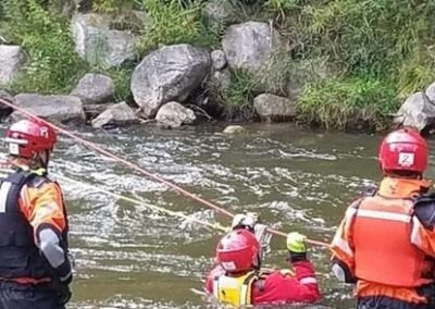 Rescuers in the river practice with rope lines across the current