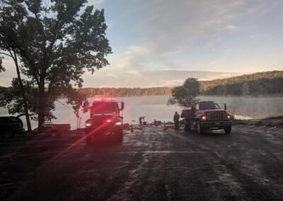 A tanker drafting water at the Sand Lake boat launch at sunrise