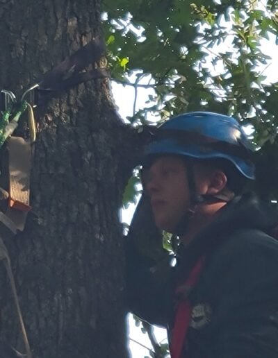 A rescuer setting straps high on a tree during tree stand rescue training, September 12, 2026