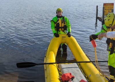 A member steadies the rescue craft in the water