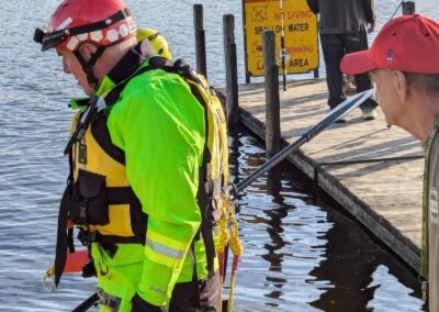 A member in a water rescue suit beside the dock