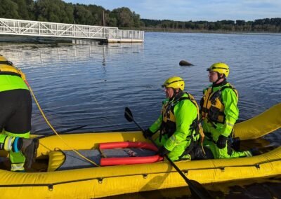 Two members kneel in the rescue craft