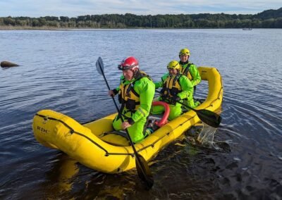 Three members paddle the rescue craft