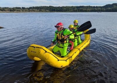 Members paddle the rescue craft away from shore